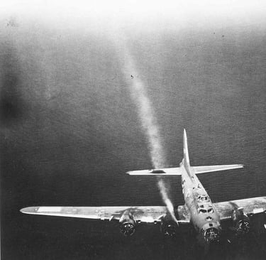 Battle damaged B-17 over water