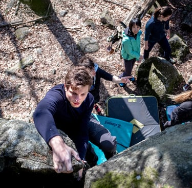 a man climbing a rock face down a steeple