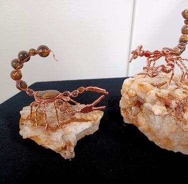 Wire wrap scorpion sculptures: copper, tiger's eye, and fire agate.