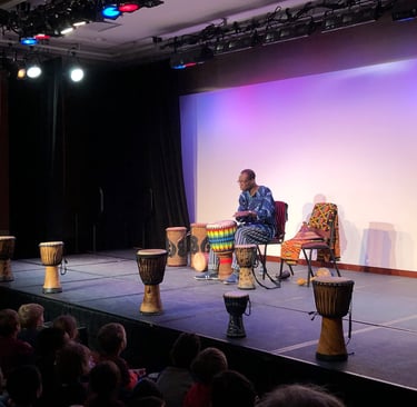 Artist Kofi Dennis performs for students at Discovery Theater in Washington, DC
