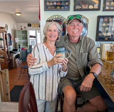 Maggie and Pete sitting at the bar with their special mugs