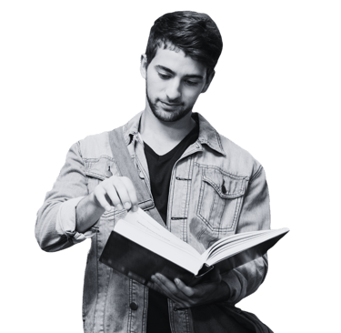 A man reading a book he is holding open