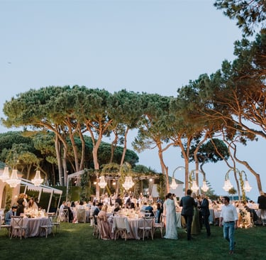 Evening wedding reception at Villa El Rincon with chandeliers and garden dining