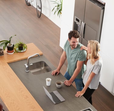 a man and woman standing in a kitchen