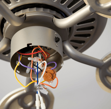 a fan with wires and wires attached to a ceiling fan