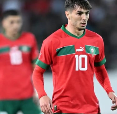 a soccer player in a red jersey and green pants