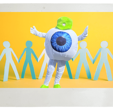 Edge Optics' eyeball mascot standing in front of people cutouts