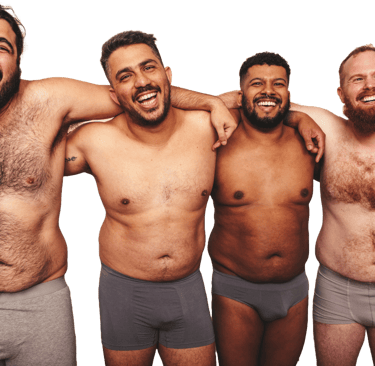 4 shirtless men of different skin tones and sizes with their arms on each other's shoulders