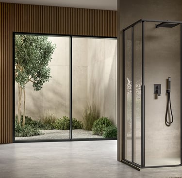 a bathroom with a glass shower and a shower