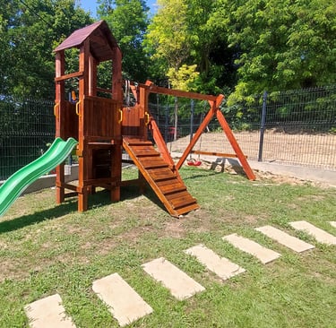 a wooden swing set with a slider and slider