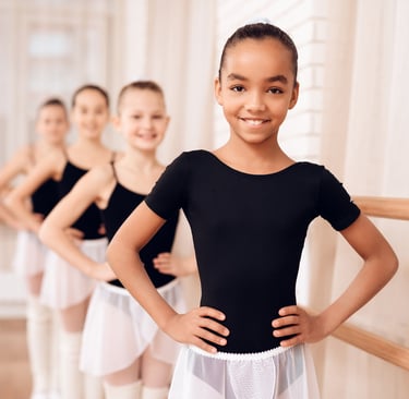 a group of young girls in ballet wear
