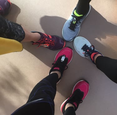 a group of people standing in a circle with their feet on the ground