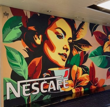 Colorful indoor mural with female face and Nescafé logo, artistic work by Poliops.