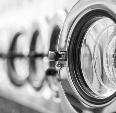 a bunch of laundry machines in a row