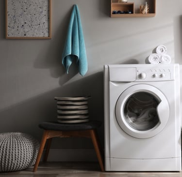a laundry room with a washing machine and a laundry basket