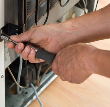 a man is fixing a dishwasher in a dishwasher