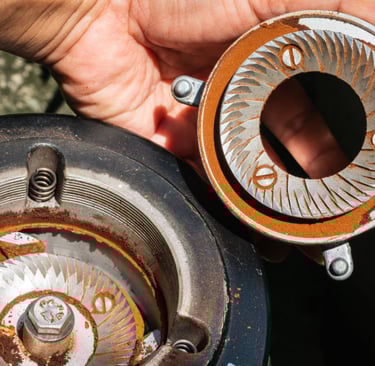 a person holding a piece of metal with a ring
