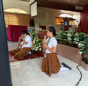 Elementary Student kneeling and praying with a mic