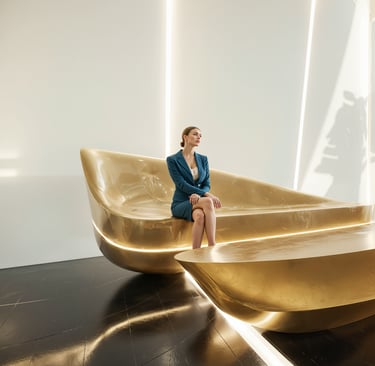 Luxury custom furniture design featuring sculptural lounge seating with brushed brass base