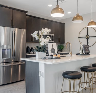 a kitchen with a large island and a bar stool