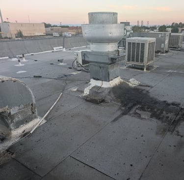 2 years of roof top hood cleaning grease spillage on asphalt roof. Grease will bond to the asphalt.