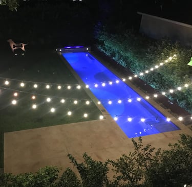 string lighting, strip lighting and accent up lights on statue