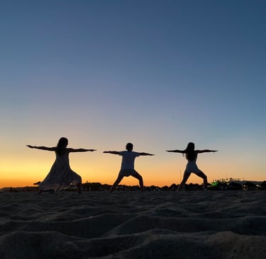 Katie Prickett Warrior 2 pose with daughters on beach