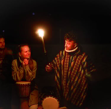 a man holding a torch telling his story and 2 people listening staring at him. Photo by Martin Vähk