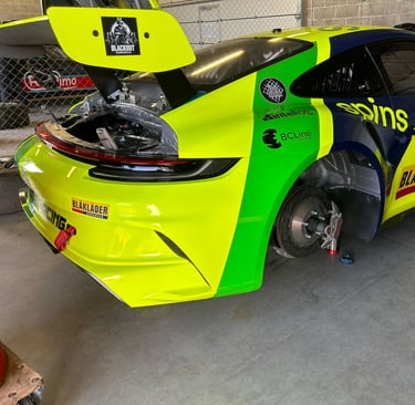 an Enlab yellow and green Porsche car with a yellow and black car in the background