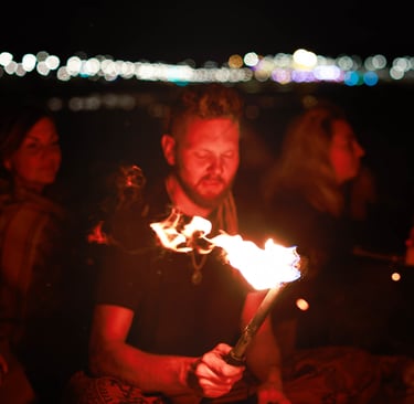 A man holds a torch while others listen his story. Photo by Martin Vähk