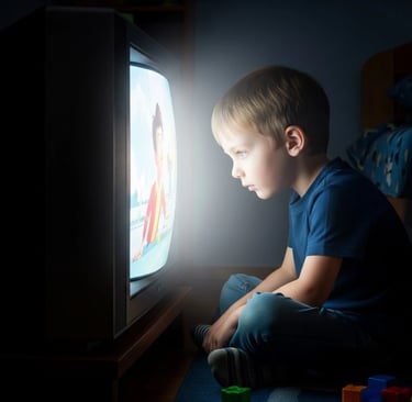 A child watching TV too closely.