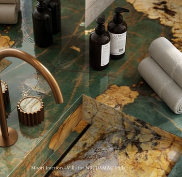 Close-up of a Green marble countertop with gold faucet and accessories in a modern bathroom.