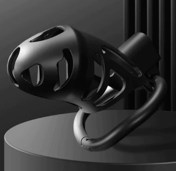 a black and white chastity cage on a pedestal 