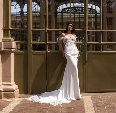 a woman in a white dress standing in front of a large building