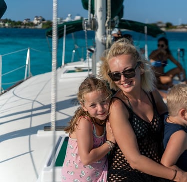 a woman and two children on a boat in cancun 