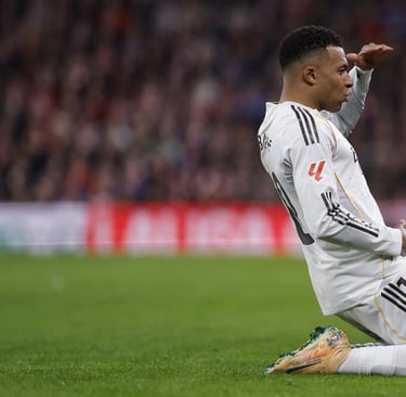 a man sitting on a soccer field with his foot in the air