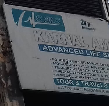 An image showing a board with details of Karnal Ambulance Service in Karnal