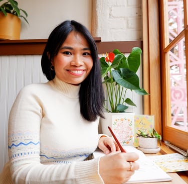 New York City Calligrapher smiling and holding a nib and pen holder