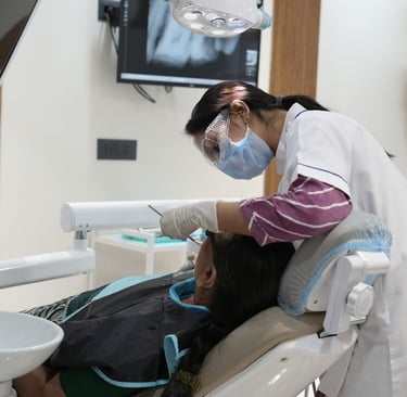 Dentist performing oral health checkup in a modern dental clinic in Gandhinagar