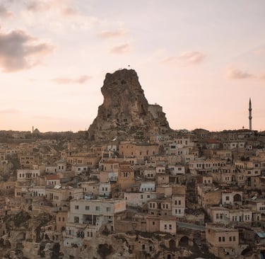 Sunset over Uçhisar Castle and stone village in Cappadocia, Turkey