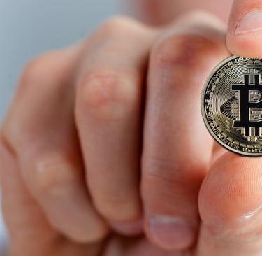 a person holding a bitcoin coin