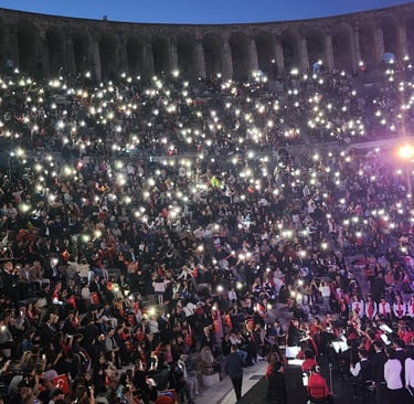 a large crowd of people standing in front of a stage