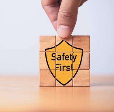 Building blocks with the graphic of a yellow shield saying "Safety First" on the front