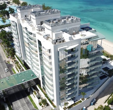 Luxury residential high-rise—The Watermark, Cayman, viewed from the beach with modern architect