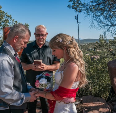 a man and woman getting married in a mountaintop