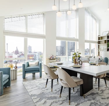 a living room with a large table and chairs