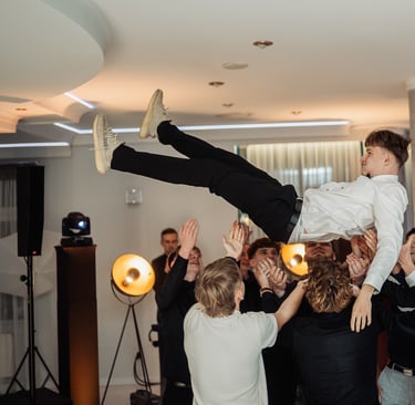 a man is doing a trick on a man in a suit and tie