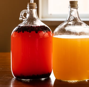 Two jugs of liquid (mead), one orange and one gold