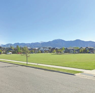 a street scene with a street sign and a car parked on the side of the