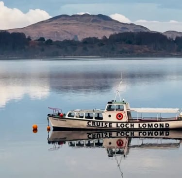 white boat on Loch Lomond with hills in the background